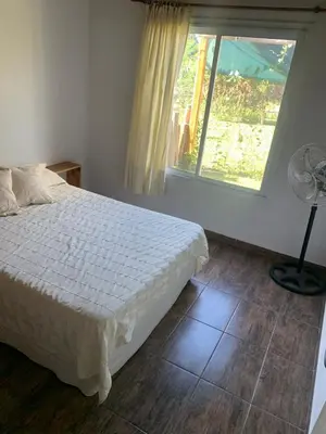 a bedroom with a white bed and a window at El despertar Hospedaje in San Francisco del Monte de Oro
