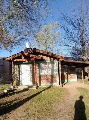 a log cabin building with a large window at Cabaña particular no complejo in Santa Rosa de Calamuchita