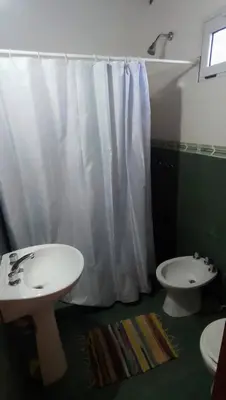 a bathroom with a white sink and a toilet at Cabaña particular no complejo in Santa Rosa de Calamuchita
