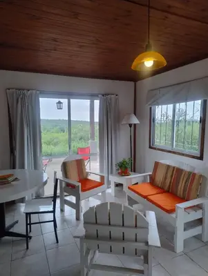 a living room with a couch and chairs and a table at Tinkunaco Alta Gracia in Alta Gracia