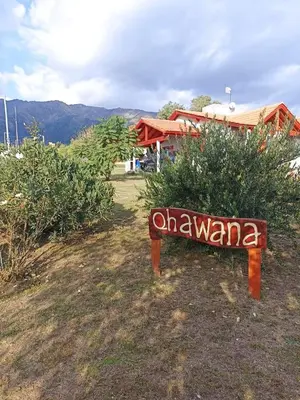 a sign that says okayama in front of a bush at Cabañas Qhawana in Carpintería
