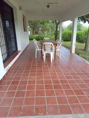 a patio with a table and chairs on a brick floor at Casa en Santa Rosa de Calamuchita in Santa Rosa de Calamuchita