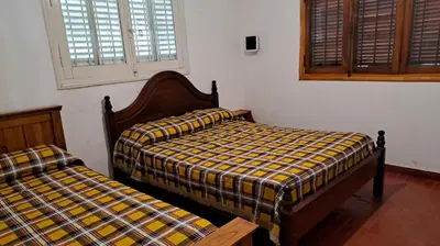 two beds sitting next to each other in a room at Casa en Santa Rosa de Calamuchita in Santa Rosa de Calamuchita
