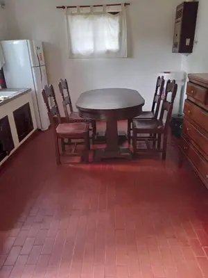 a dining room table and chairs in a kitchen at Casa en Santa Rosa de Calamuchita in Santa Rosa de Calamuchita