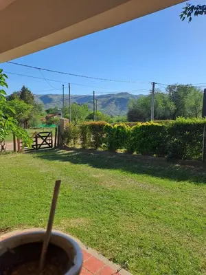 a cup of coffee on a table in a yard at Casa en Santa Rosa de Calamuchita in Santa Rosa de Calamuchita