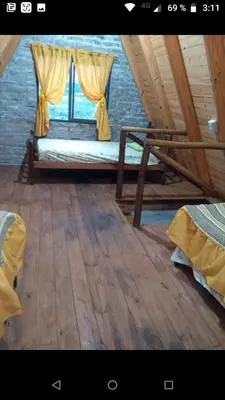 a room with a bed and a window on a boat at Cabañas Alpinas M y M in Bialet Massé