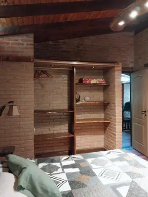 a room with a brick wall with a bed in it at soy ahora in Pueblito
