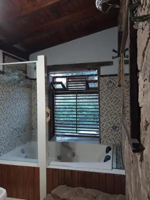 a bath tub in a bathroom with a window at soy ahora in Pueblito