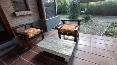 two chairs and a bench on the porch of a house at soy ahora in Pueblito