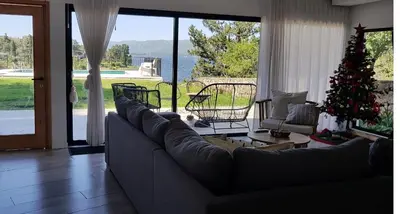a living room with a couch and a christmas tree at Casalago in Villa Carlos Paz