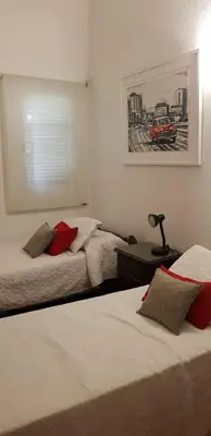 a bedroom with two beds and a picture on the wall at Casalago in Villa Carlos Paz