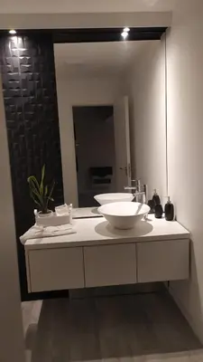 a bathroom with a sink and a large mirror at Casalago in Villa Carlos Paz