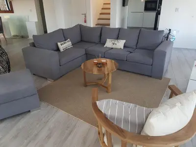 a living room with a blue couch and a table at Casalago in Villa Carlos Paz