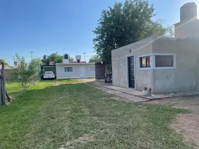 a small house with a yard in front of it at Departamentos M&M in Villa Cura Brochero