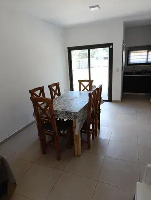 a dining room table and chairs in a room at La casona de Yatel in Santa Rosa de Calamuchita