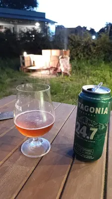 a glass of wine next to a can on a table at La casona de Yatel in Santa Rosa de Calamuchita