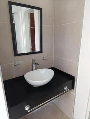 a bathroom with a sink and a mirror on a counter at La casona de Yatel in Santa Rosa de Calamuchita