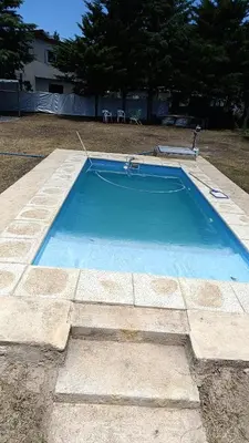 a large blue swimming pool in a yard at La casona de Yatel in Santa Rosa de Calamuchita