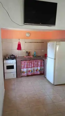 a kitchen with a stove and a white refrigerator at Happy House in Tanti