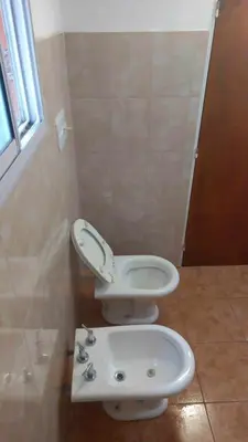 a bathroom with a toilet and a sink at Happy House in Tanti