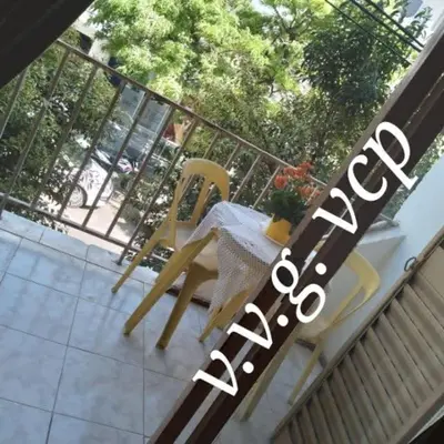 a balcony with a table and a yellow chair at Departamento centro Carlos Paz in Villa Carlos Paz