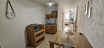 a kitchen with a table and a clock on the wall at Monoambiente Centro in Cordoba