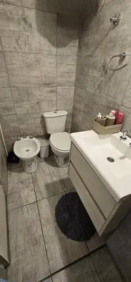 a bathroom with a toilet and a sink at Monoambiente Centro in Cordoba