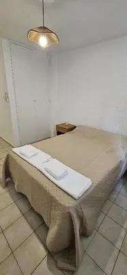 a large bed in a room with a light at Monoambiente Centro in Cordoba