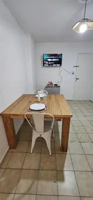 a wooden table with a chair in a room at Monoambiente Centro in Cordoba