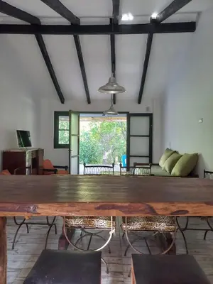 a large wooden table in the middle of a room at Amaneceres de Cabalango in Cavalango
