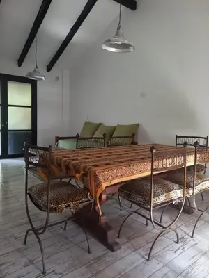 a wooden table with chairs in a room at Amaneceres de Cabalango in Cavalango