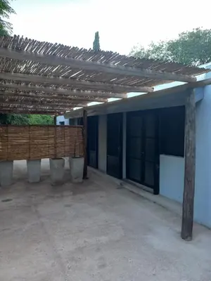 a patio with a wooden pergola on a building at Amaneceres de Cabalango in Cavalango