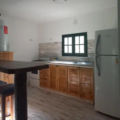 a kitchen with a white refrigerator and a window at Amaneceres de Cabalango in Cavalango