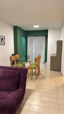 a living room with a couch and a table and chairs at Duarte Quiros Apartamento in Cordoba