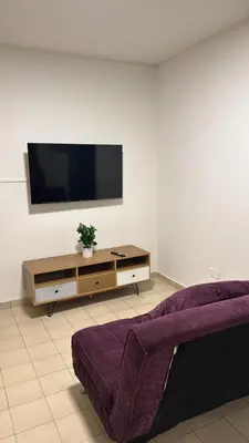 a living room with a flat screen tv on a wall at Duarte Quiros Apartamento in Cordoba
