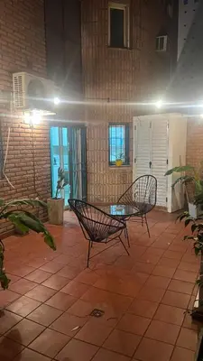 a patio with two chairs and a table in a building at Duarte Quiros Apartamento in Cordoba