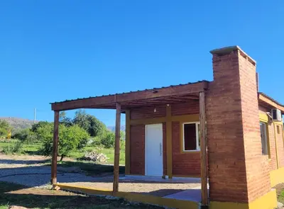 a small brick house with a roof at Pedrolandia in Mina Clavero