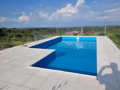 a blue swimming pool on the roof of a house at Pedrolandia in Mina Clavero