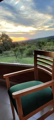 a wooden chair sitting in front of a window at Pedrolandia in Mina Clavero