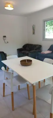 a white table with a bowl on it in a living room at La casa del león in San Antonio de Arredondo