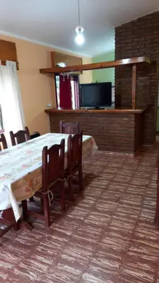 a dining room with a table and chairs and a tv at Abu Ma! in Tanti