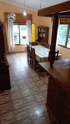 a dining room with a table and chairs in a room at Abu Ma! in Tanti