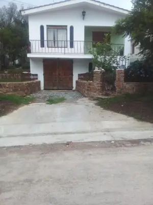 a white house with a porch and a driveway at Abu Ma! in Tanti