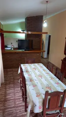 a dining room with a table with chairs and a fireplace at Abu Ma! in Tanti