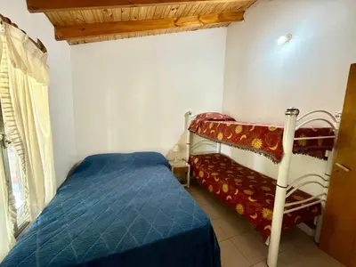 a bedroom with two bunk beds and a window at Mina Clavero Chalet in Mina Clavero