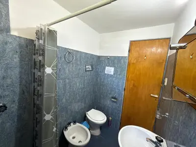 a bathroom with a sink and a toilet and a shower at Mina Clavero Chalet in Mina Clavero