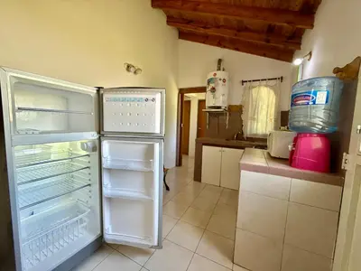a kitchen with an open refrigerator in a room at Mina Clavero Chalet in Mina Clavero