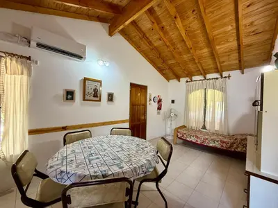 a dining room with a table and chairs at Mina Clavero Chalet in Mina Clavero