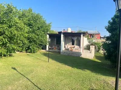 a house with a porch with a couch in a yard at Complejo Don otto in Cavalango
