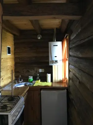 a kitchen with a stove and a sink in a cabin at Enkel Cabañas in José de la Quintana